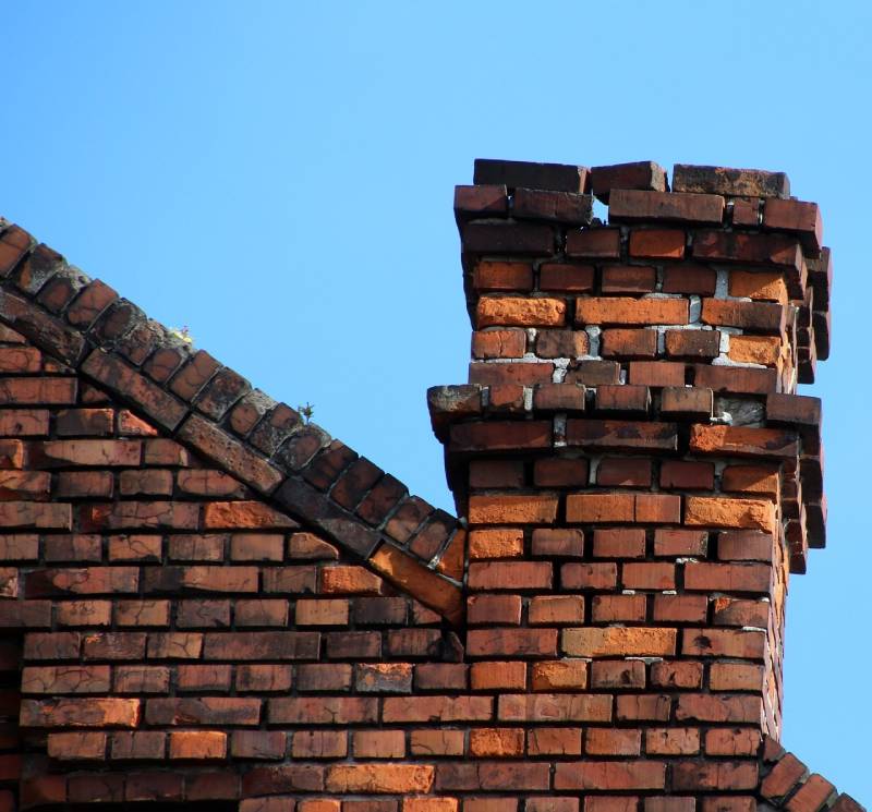Damaged chimney on an Thornton home showing cracks and missing mortar